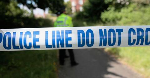 A representational image of a police line at a crime scene.