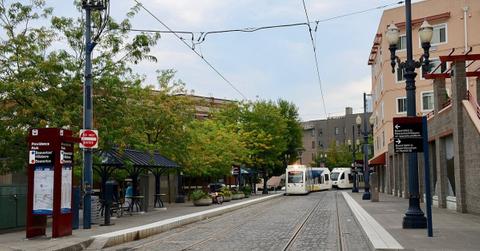 Providence Park MAX light rail station platform in Portland, Oregon, with train tracks and waiting area visible.